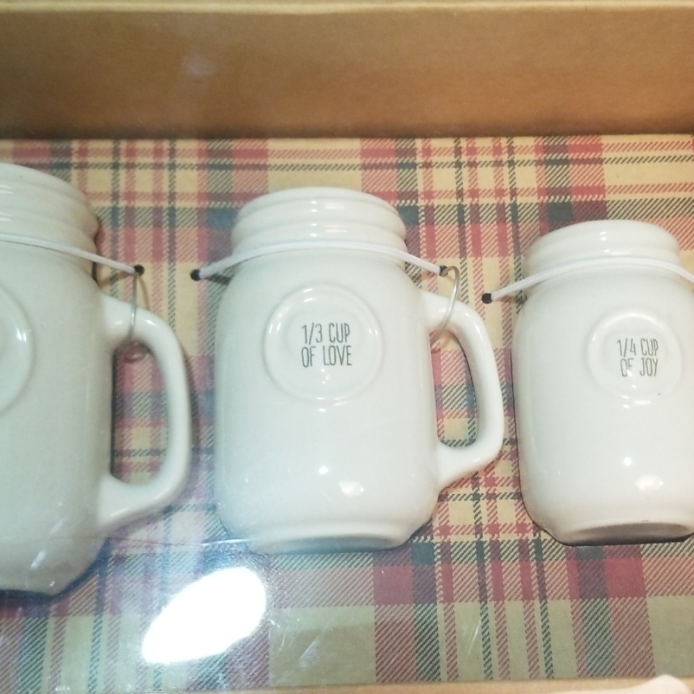 4 measuring cups filled with kiss, hugs, love, joy